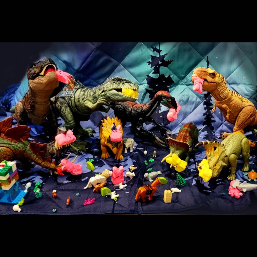 Tableau of toy dinosaurs eating various Peeps